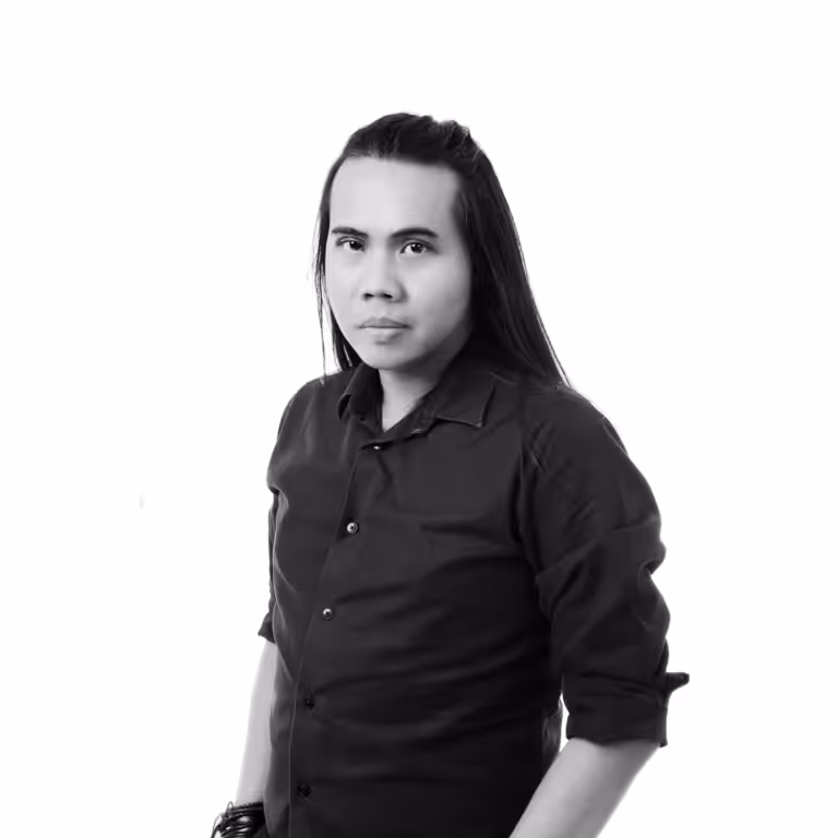 Yassir Yahya in a dark shirt, black-and-white studio portrait.